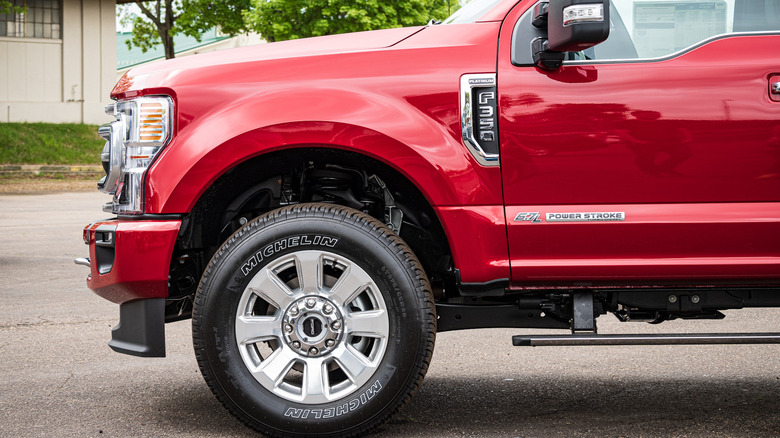 A side-profile view of a red Ford heavy-duty truck with a 6.7 Power Stroke badge.