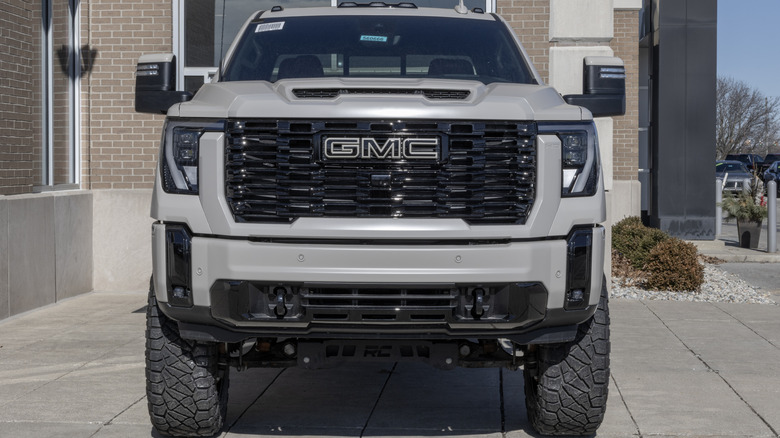 A front-end view of a gray 6.6 Duramax GMC Sierra.