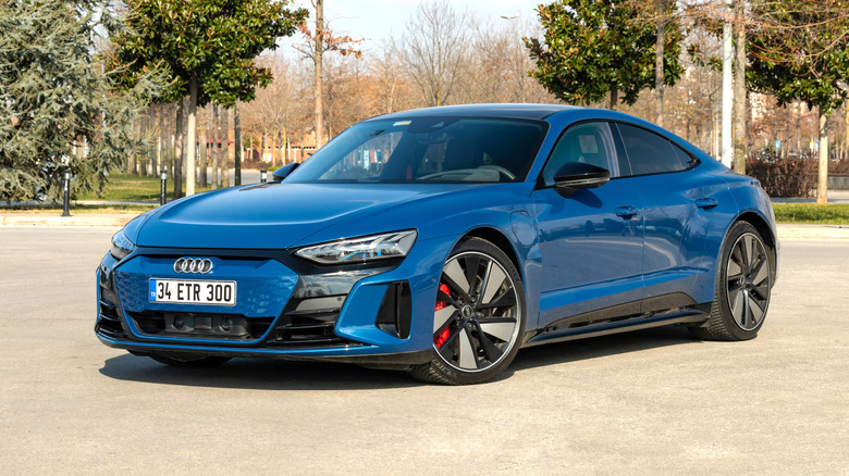 A blue Audi e-tron GT luxury EV parked outside.