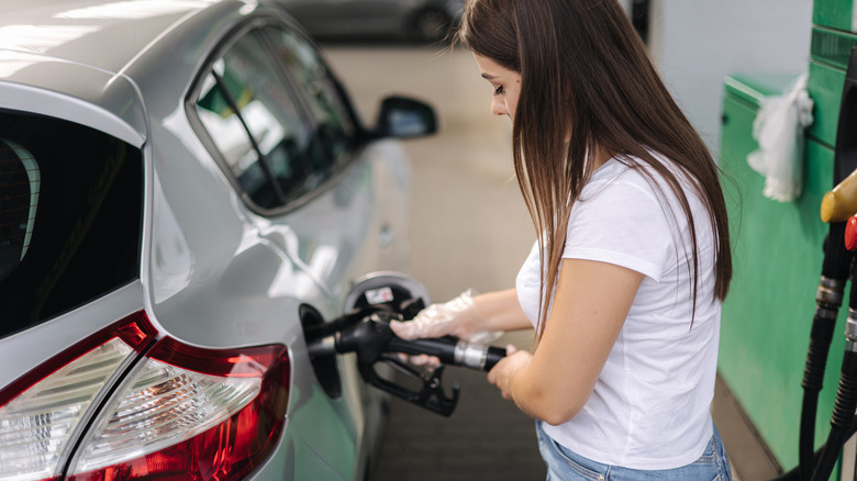 Woman refueling a car