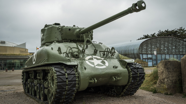 An American WW2 Sherman M4 tank parked in a rural setting.