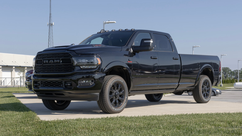 A black Ram 3500 heavy-duty truck parked outside near grass.