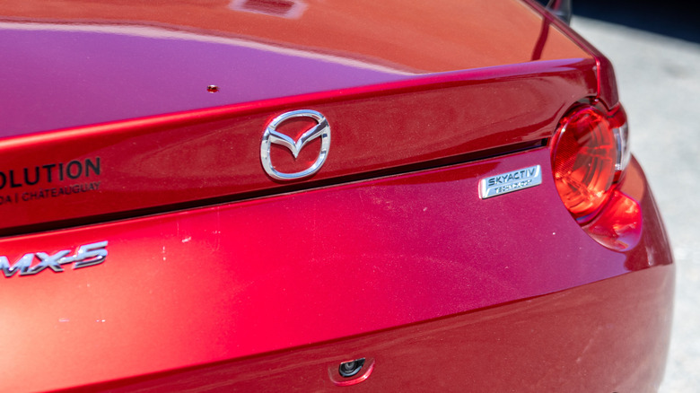 A rear-end close-up of a Mazda MX-5 Miata badge.
