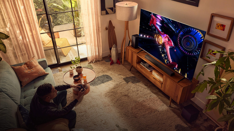 A person plays a video game on a TV in a living room