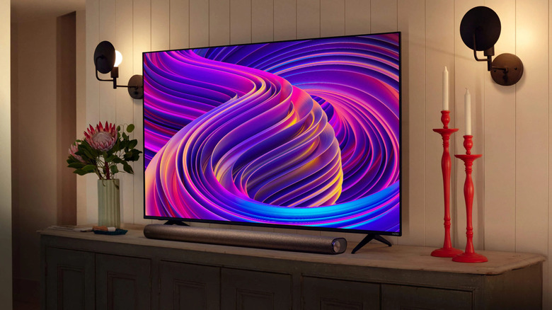 A Vizio television on a stand with a soundbar
