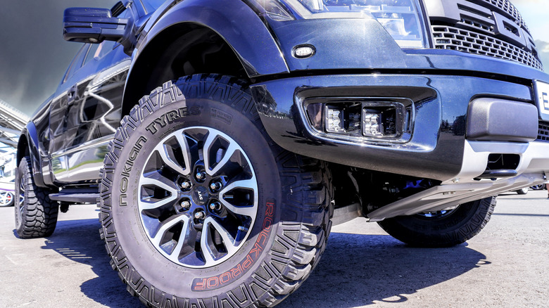A front-end close-up of a view of Ford F150 Raptor wearing Nokian tires.