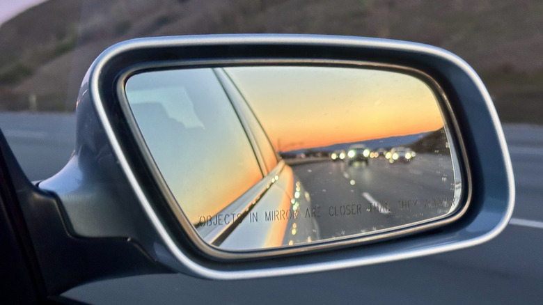 A close-up of a car's wing mirror from the inside.
