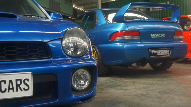 Two Subaru WRX STi's parked next to each other.