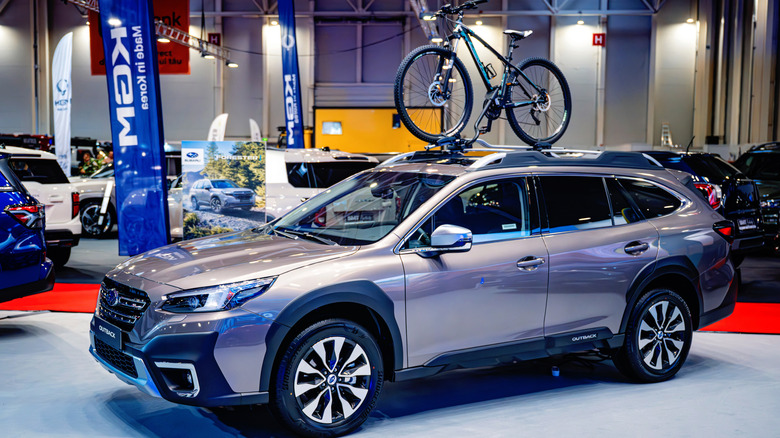 A bronze metallic Subaru Crosstrek on display with a roof rack.
