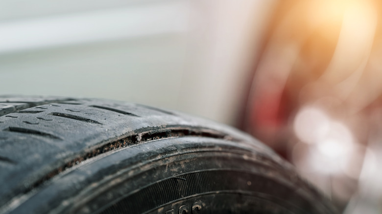 A close-up of a badly worn out car tire.