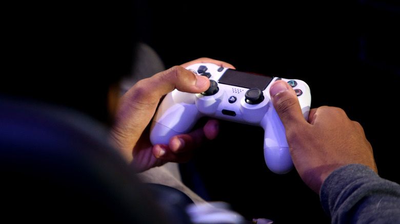 man using PS4 controller