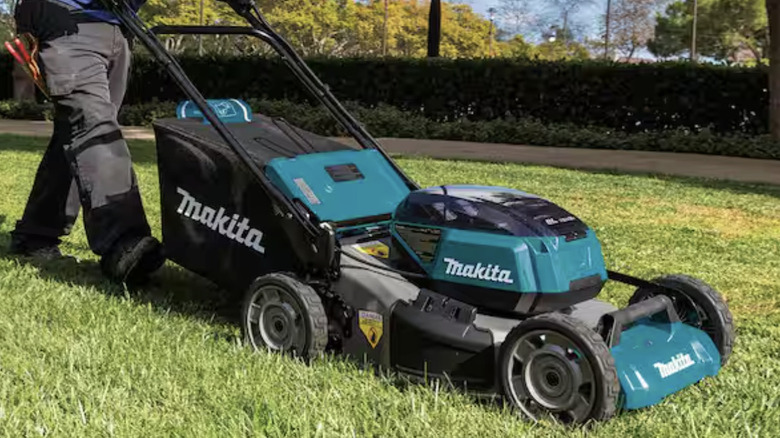 Close-up of a man using the Makita 36V LXT 21" Self-Propelled Lawn Mower