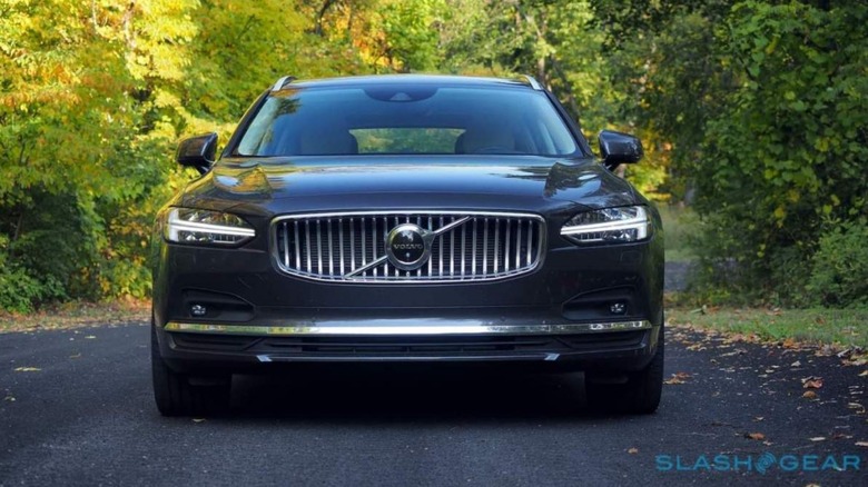 Volvo V90 on wooded road 