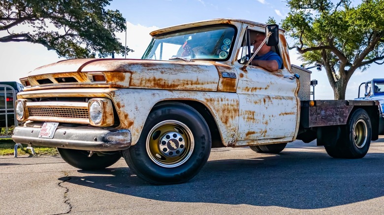 A 292-cubic inch inline-6 equipped mid-1960's Chevy C30 flatbed showing considerable patina.