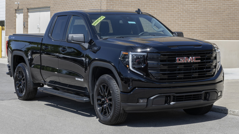 Black GMC Sierra 1500 Elevation 3VL parked in front of a building