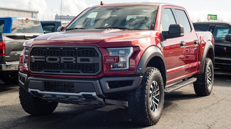 Red 2020 Ford F-150 Raptor pickup truck in a parking lot