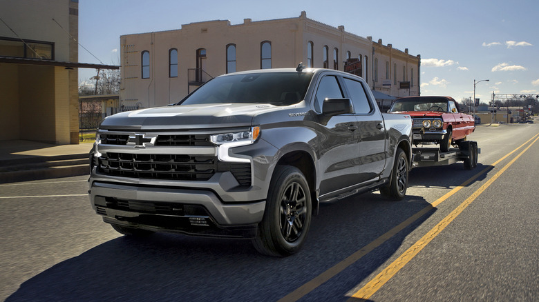 Chevrolet Silverado 1500 RST towing an old Impala