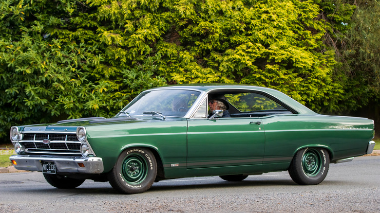 A green Ford Fairlane on matching green steel wheels, front 3/4 view