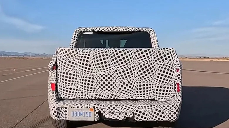 Rear view of Ford's upcoming EV pickup in camo