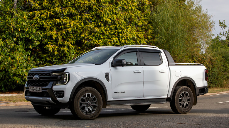 A white 2024 Ford Ranger exiting an intersection, front 3/4 view