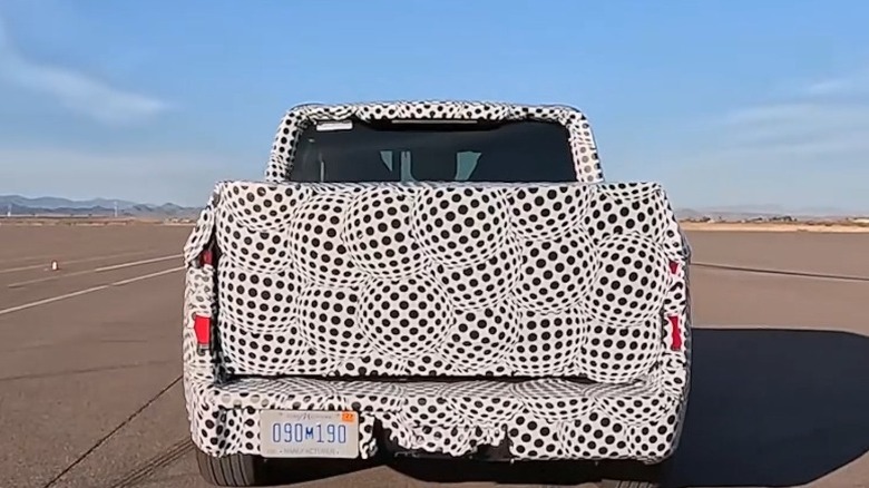 Rear view of Ford prototype EV truck showing camouflage pattern