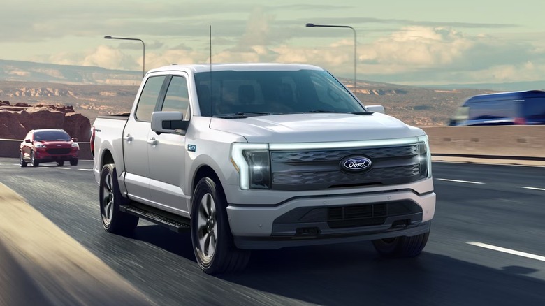 Front quarter view of a Ford F-150 Lightning driving down a highway