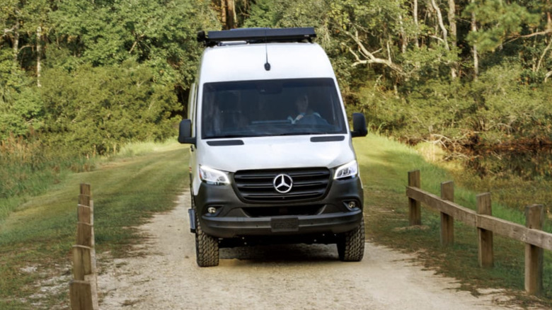 Mercedes-Benz Sprinter van driving on a dirt road
