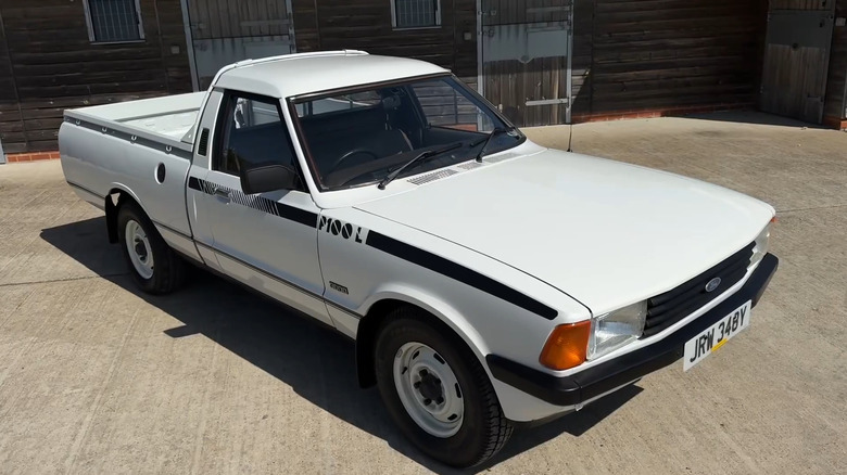 A white Ford Cortina MkV Pick-Up, also called 3000 Bakkie, in front of a house.