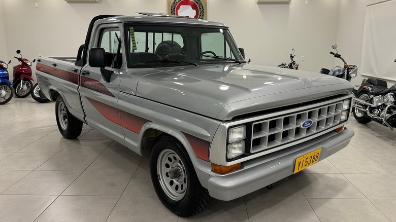 A 1990 Ford F-1000 pickup truck in a garage.