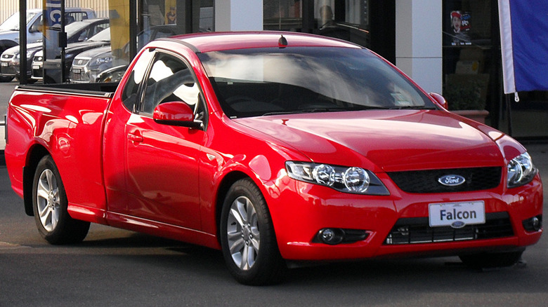 A red 2008 Ford Falcon R6 pickup truck on the road in australia.