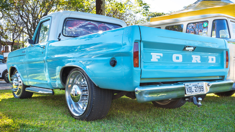 Vintage light blue Ford F-1000 pickup truck showcased at a car show in Brazil