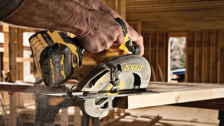 Person cutting wood with DeWalt 60V Max 7 ¼-inch Brushless Circular Saw