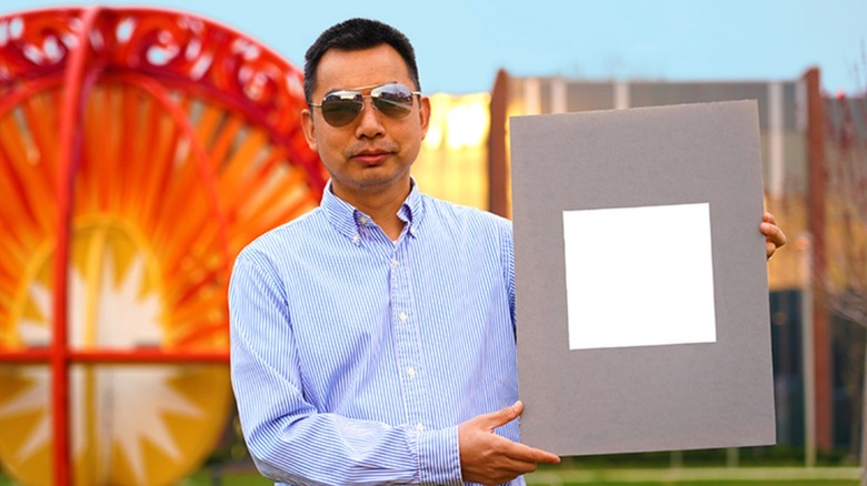 Man holding whitest white square