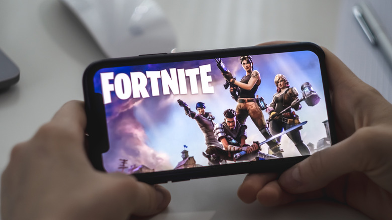 Man playing Fortnite on his smartphone.