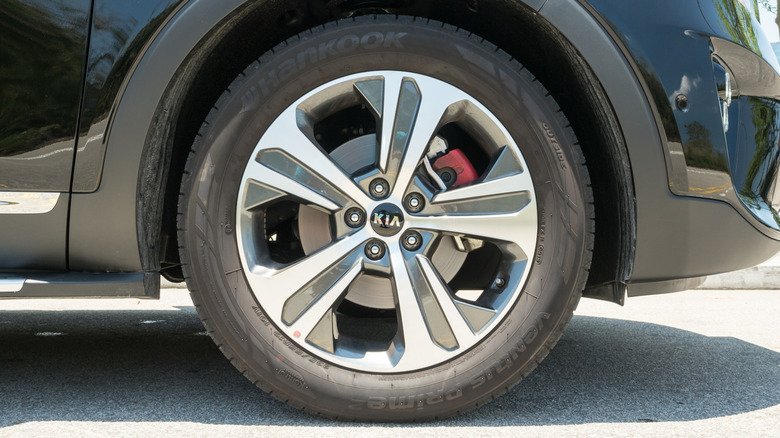A close-up of a black Kia SUV wearing Hankook tires.