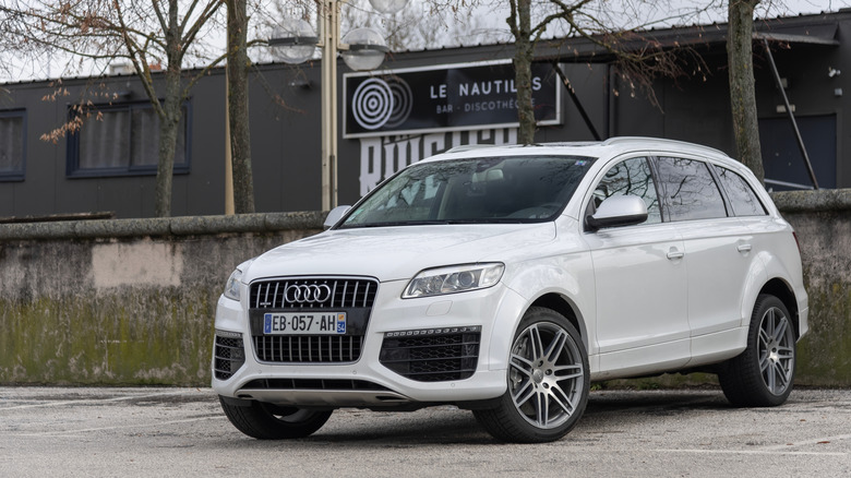 A white V12 Audi TDI Q7 parked on the street.