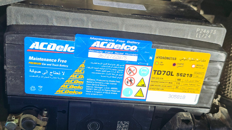 A close-up view of an ACDelco battery installed in a vehicle.
