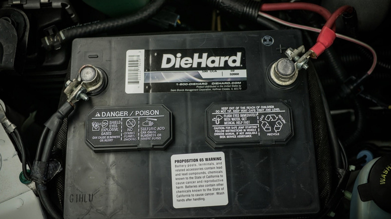 A close-up view of a DieHard car battery installed.