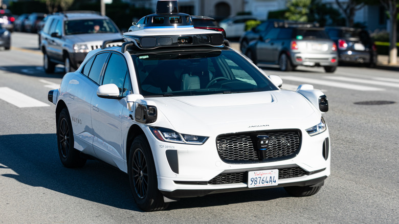 Waymo One Jaguar autonomous car drives on a multi-lane city road