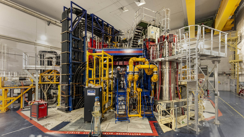 A worker examines the WEST Tokamak run by CEA.