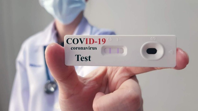 Doctor holding COVID test