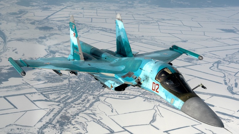 An Su-34 flying over a snow-covered landscape in Buturlinovka, Oblast, Russia.