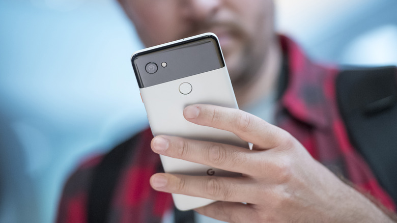 Person using a Pixel 4 smartphone.