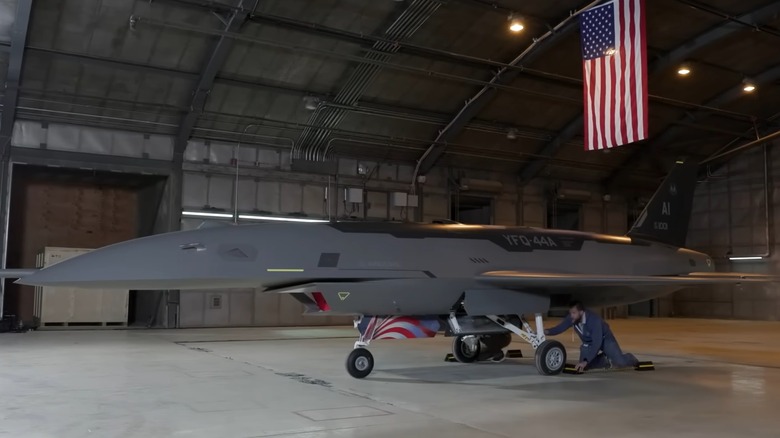 A technician works on the The YFQ-44A Fury AAV in a hangar