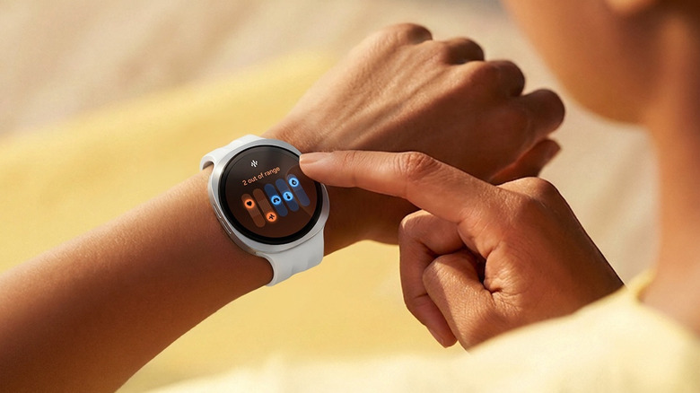 A person uses a white Samsung Galaxy Watch 9