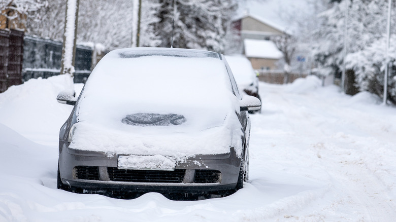 Cars on the street in heavy snow.