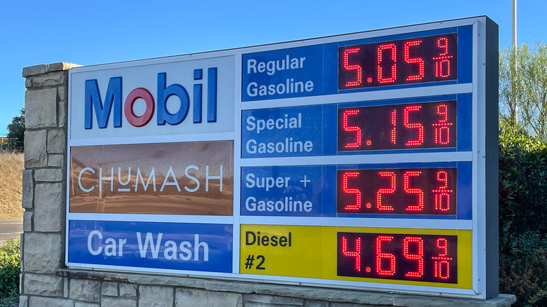 A sign for a Mobil gas station advertising prices over $5 per gallon