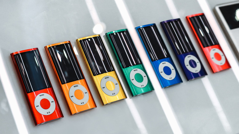 A row of iPod Nanos in rainbow order.
