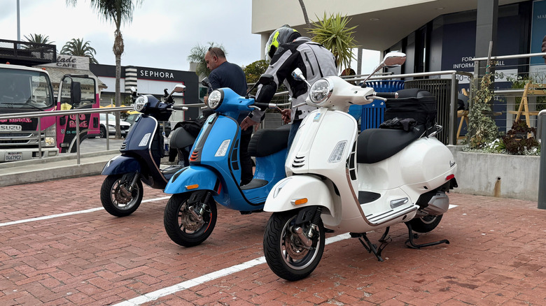 A group of Vespa 310 scooters parked together in Malibu, CA