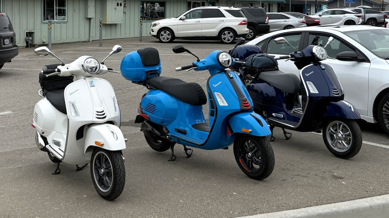 Three Vespa 310 scooters parked side by side